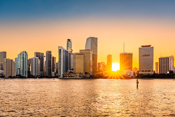 Miami, Florida skyline with sunbeams shining through the skyscrapers. Miami is a majority-minority city and a major center and leader in finance, commerce, culture, arts, and international trade.