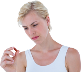 Concentrated blonde woman looking at red pill