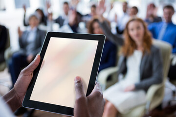 Businessperson using digital tablet during meeting