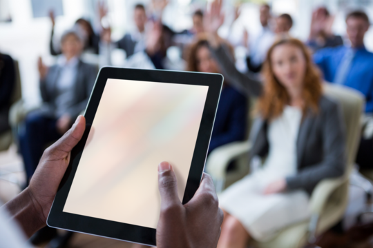 Businessperson using digital tablet during meeting