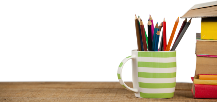 Stack of books by mug with colored pencils on wooden table - Powered by Adobe