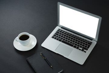 Black coffee, pen, organizer and laptop on black background