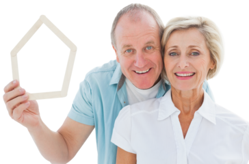 Happy older couple holding house shape