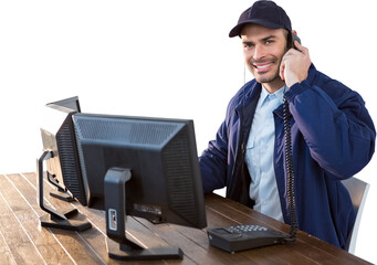 Portrait of happy security officer talking on phone at desk