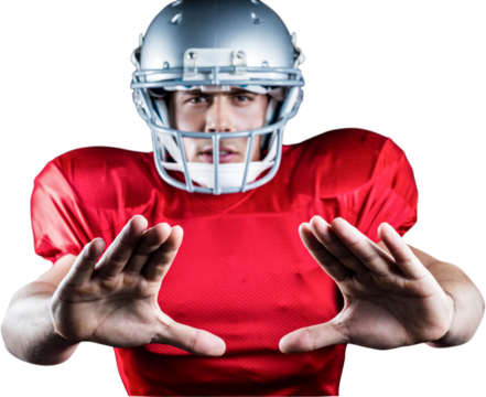 Portrait of sportsman defending while playing American football