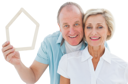 Happy older couple holding house shape