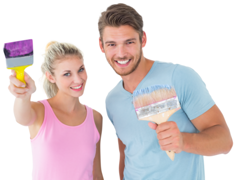 Young couple smiling and holding paintbrushes  - Powered by Adobe