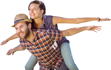 Man piggybacking woman with arms outstretched