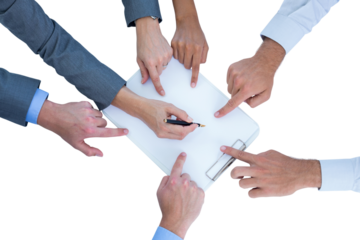 Businesswoman writing on clipboard while colleagues pointing on it
