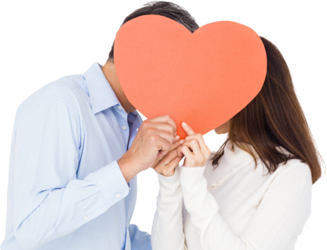 Couple covering face with heart shape paper