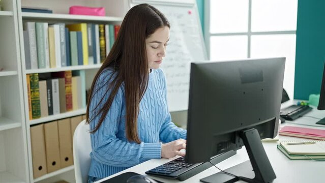 Young caucasian woman student using computer studying at library university