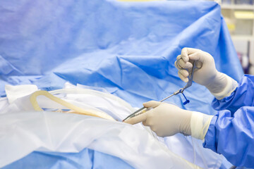 Doctor or surgeon in blue gown did endoscopic spine surgery inside orthopedic operating room with...