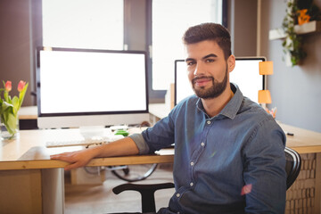 Fototapeta premium Happy graphic designer sitting at office