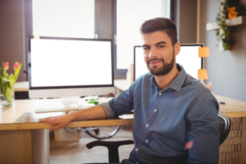 Happy graphic designer sitting at office