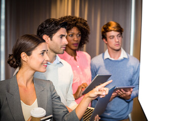 Business colleagues looking at whiteboard