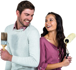 Smiling couple holding brushes