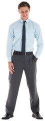 Smiling businessman standing with hand in pocket