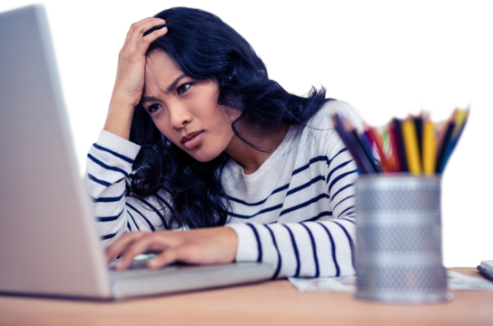 Concentrated Asian woman with hand on head using laptop