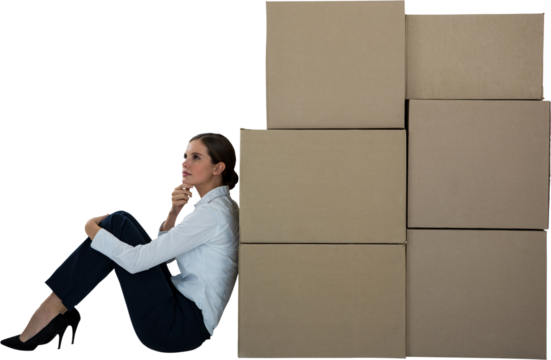 Businesswoman leaning on cardboard boxes against white background - Powered by Adobe