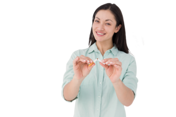 Smiling woman snapping cigarette in half