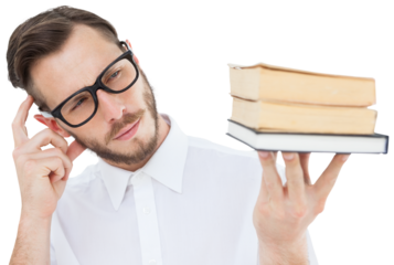 Geeky young man looking at pile of books
