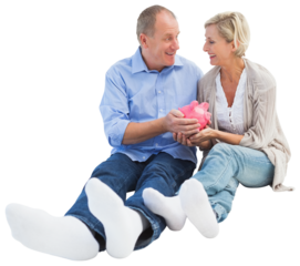 Happy mature couple holding piggy bank