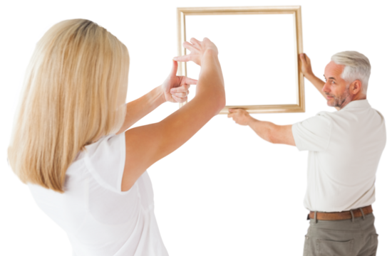 Couple hanging a frame together