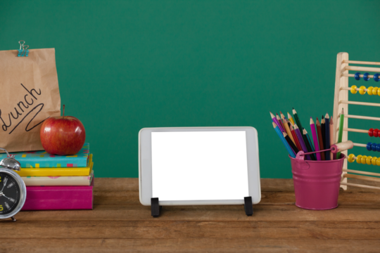School supplies with digital tablet on wooden table