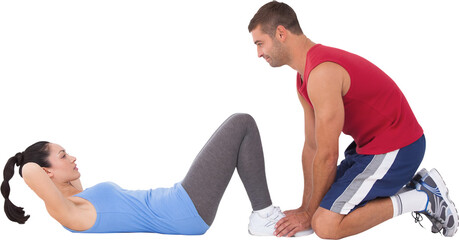 Trainer with woman doing sit ups