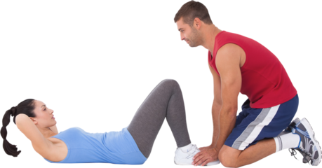 Trainer with woman doing sit ups
