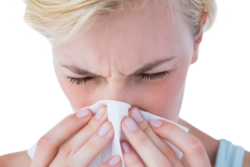 Close-up of attractive woman blowing her nose