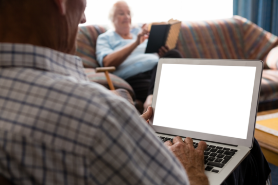 Senior man uisng laptop in nursing home - Powered by Adobe