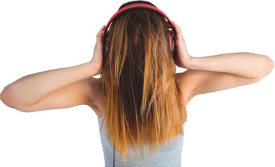 Woman covering face with hair while listening music