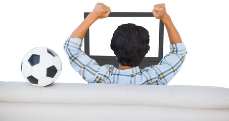 Football fan cheering while watching television