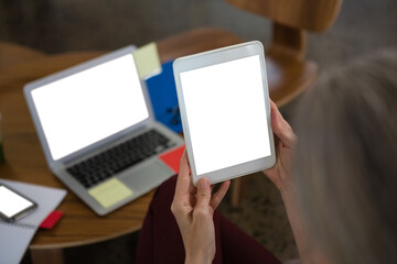 Cropped hands of businesswoman using digital tablet