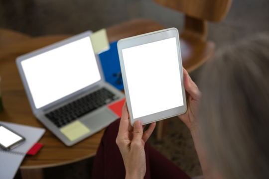 Cropped hands of businesswoman using digital tablet