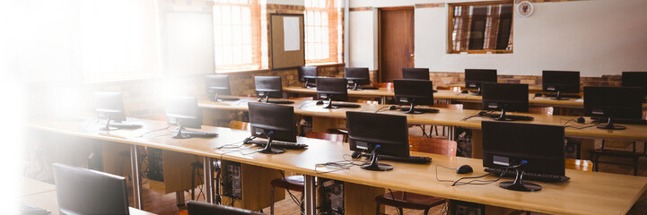 Computers on table in brightly lit office