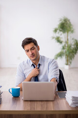 Young male employee working in the office