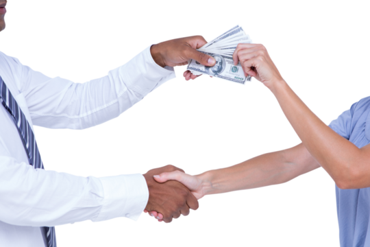Business people shaking hands and passing banknots