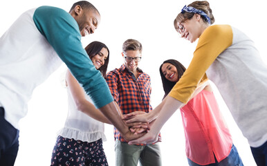 Low angle view of business people huddling hands