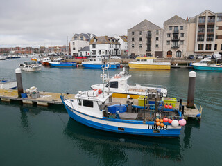 Fototapeta na wymiar Boats in the old town of Weymouth Harbour and Weymouth Marina in Dorset, England, UK