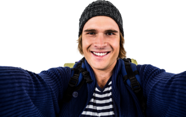 Smiling backpacker hipster holding the camera