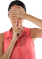 Woman covering her eyes with finger on lips against white background