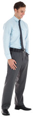 Smiling businessman standing with hand in pocket