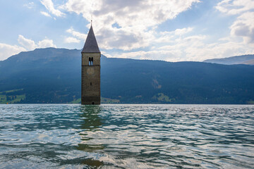 Medieval church bell tower rising from Lake Resia. Italy