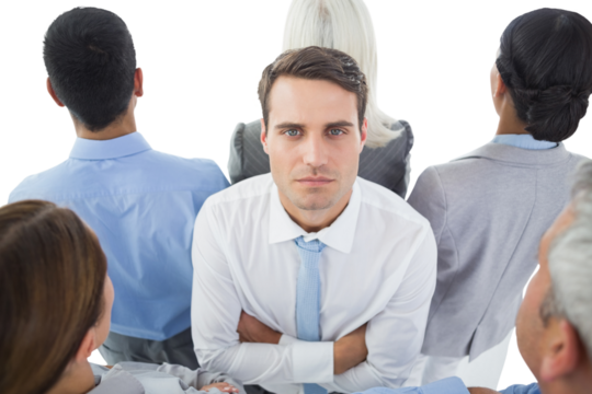 Unhappy businessman looking at camera with his colleague around him  