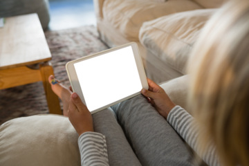 Boy using digital tablet in living room
