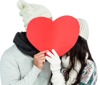 Smiling couple holding paper heart
