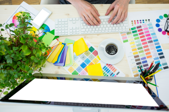Graphic designer working using computer at desk