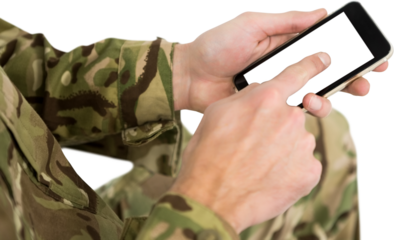 Mid section of soldier using mobile phone